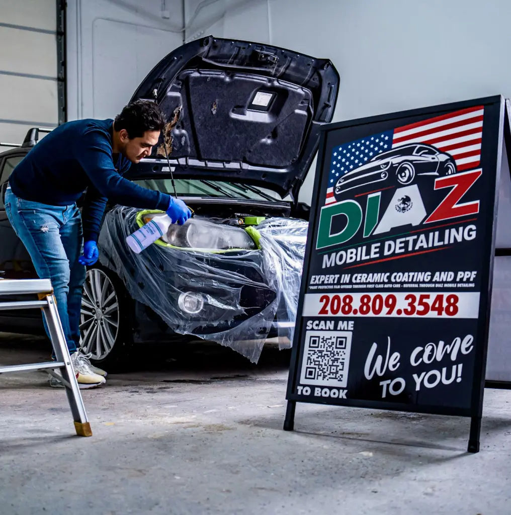 Marco from Diaz Mobile Detailing working on car with company sign in foreground 3