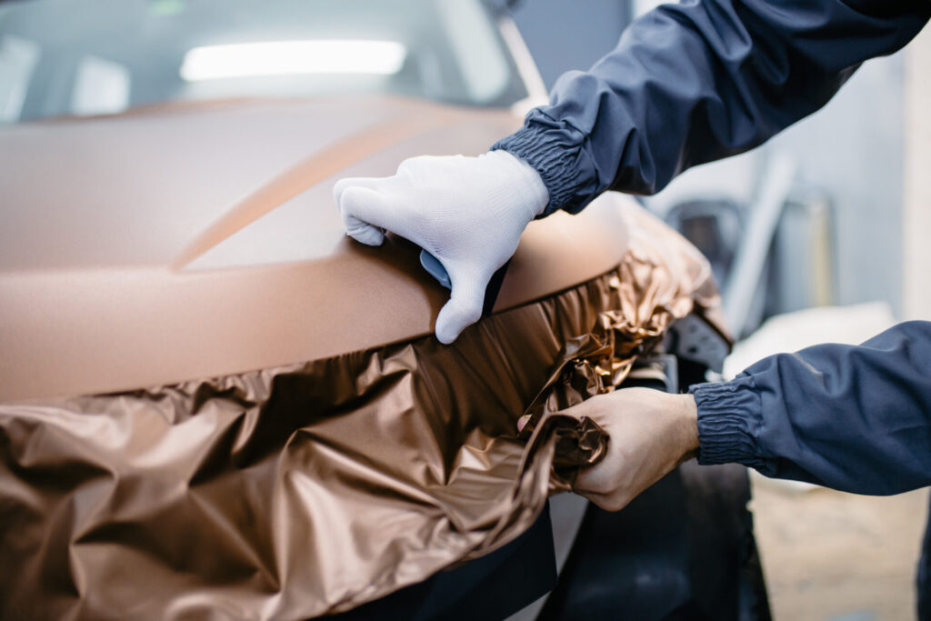 Bronze Vinyl Wrap being applied to the Hood of a vehicle